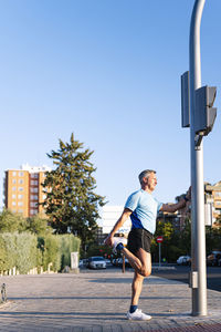 Full length of man on street against clear sky