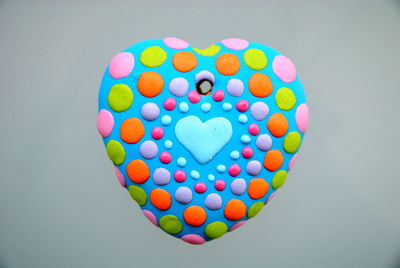 Close-up of multi colored heart shape over white background