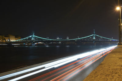 Illuminated suspension bridge at night