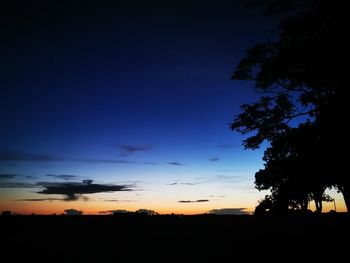 Scenic view of silhouette landscape against sky at sunset