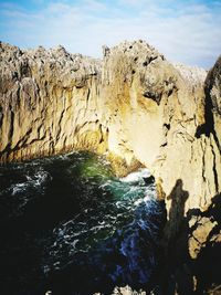 Low angle view of rock formation against sky