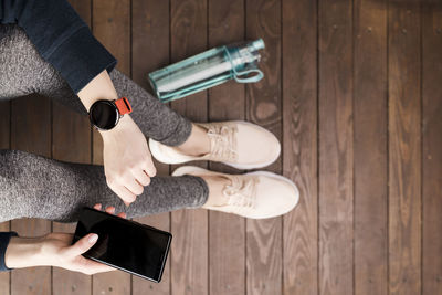 Low section of man using mobile phone