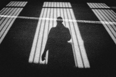 Shadow of man on road