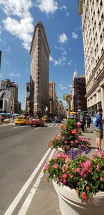 Street amidst buildings in city against sky