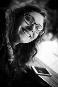 Portrait of smiling young woman with curly hair