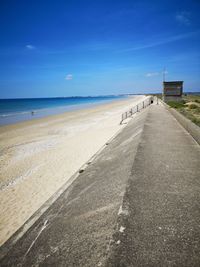 Scenic view of beach against blue sky