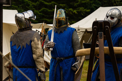 Close-up of people wearing suit of armor while standing outdoors