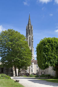 Trees and buildings against sky