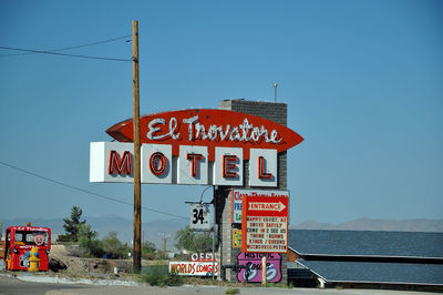 Information sign against blue sky