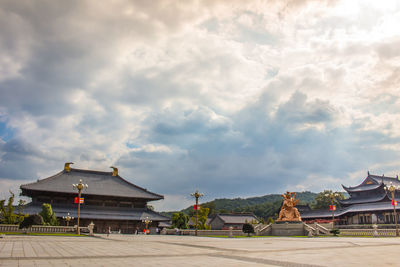 View of temple building against cloudy sky