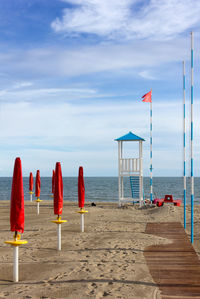 Lifeguard hut on beach against sky