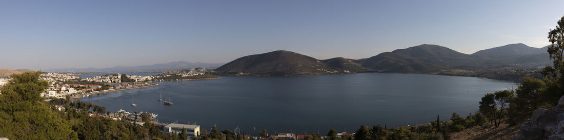 Panoramic view of sea and mountains against clear sky