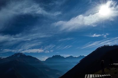 Scenic view of mountains against cloudy sky