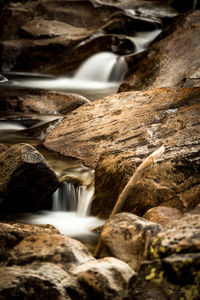 Close-up of waterfall with rocks in foreground