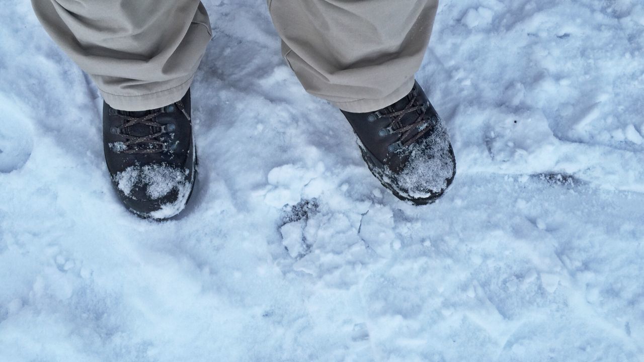snow, cold temperature, winter, season, shoe, high angle view, low section, weather, covering, frozen, person, white color, unrecognizable person, lifestyles, leisure activity, covered, footwear, standing