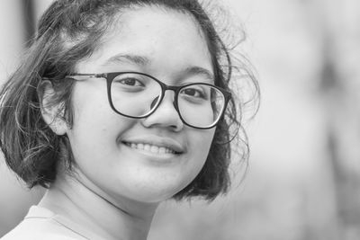 Close-up portrait of a smiling young woman