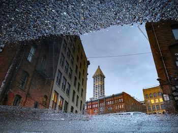 Low angle view of buildings against sky in city