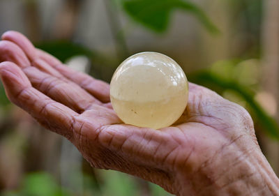 Close-up of hands holding marble