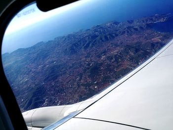 Close-up of airplane wing over sea