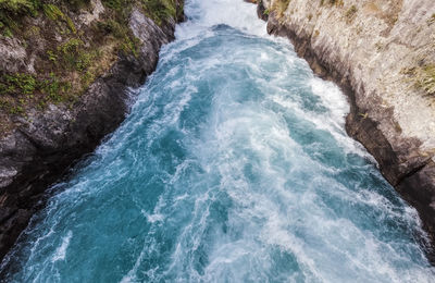 High angle view of water flowing through rocks