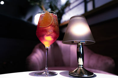 Close-up of illuminated lamp on table