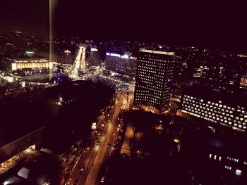 High angle view of city lit up at night