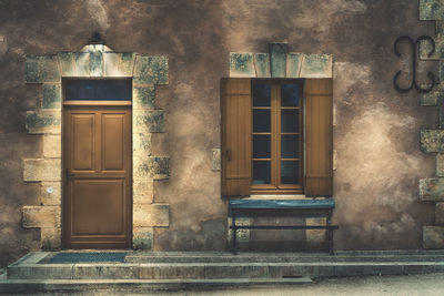 Empty bench outside house