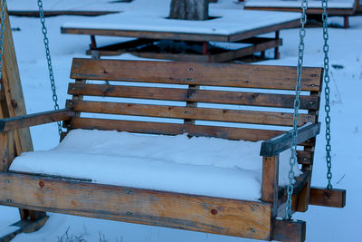 High angle view of empty bench in winter