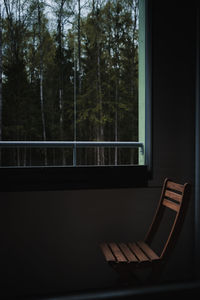 Wooden chair on a balcony with a view to forest.