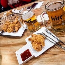 High angle view of fried chicken with beer served on table