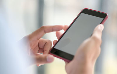 Midsection of man using mobile phone