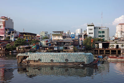 Boats in sea against clear sky