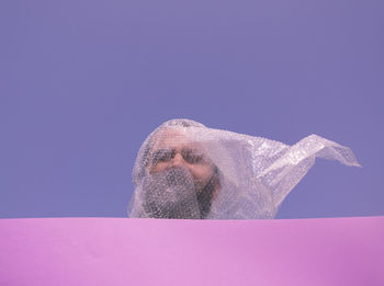 Low angle view of man against blue sky