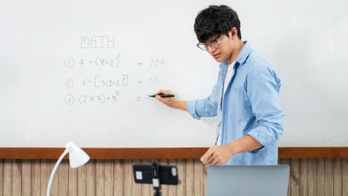 Side view of young man working at office