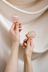 Cropped hands of person holding dentures