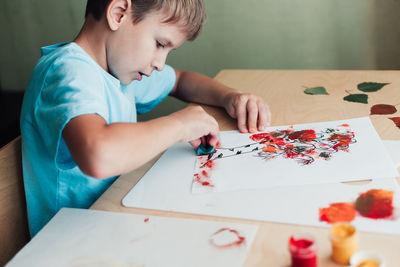 Boy playing with toy blocks at home