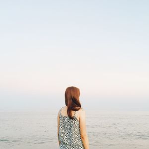 Rear view of a woman walking on beach