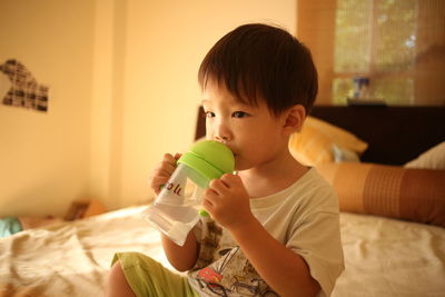 Close-up of boy drinking water