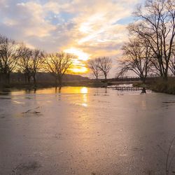 Scenic view of lake at sunset