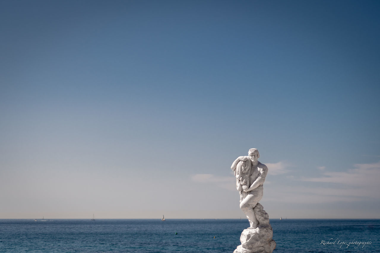 STATUE OF SEA AGAINST CLEAR SKY