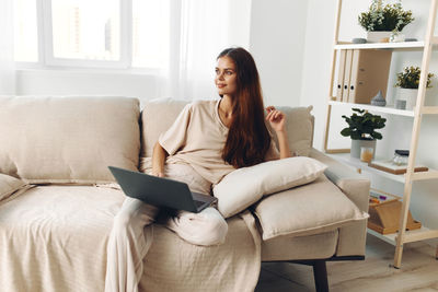 Young woman using laptop at home