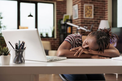 Young woman using laptop at home