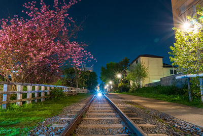 View of illuminated railroad tracks at night