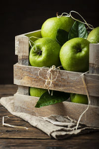 Close-up of apples in container against black background