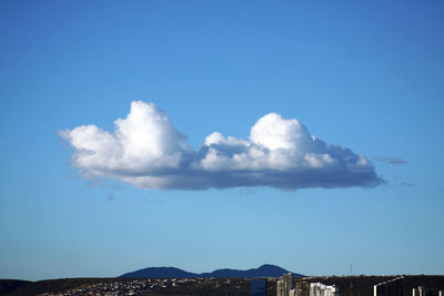 Low angle view of mountain against blue sky