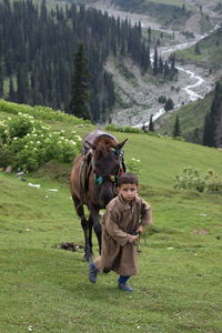 A little cute kashmiri kid about to ride a horse . so beautiful