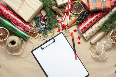 Shopping and christmas gift list. view from above. a table filled with materials for packing and