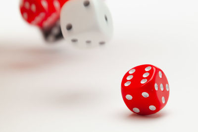 Close-up of red ball on table against white background