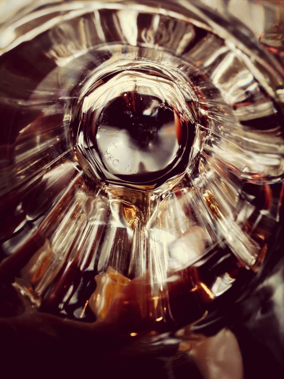 indoors, close-up, glass - material, shiny, transparent, still life, focus on foreground, reflection, no people, part of, selective focus, metal, pattern, drinking glass, circle, high angle view, glass, detail, food and drink