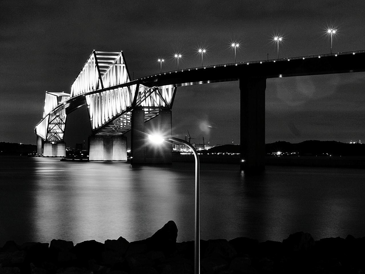 connection, illuminated, bridge, built structure, bridge - man made structure, night, sky, architecture, transportation, water, engineering, nature, river, lighting equipment, cloud - sky, building exterior, outdoors, city, light